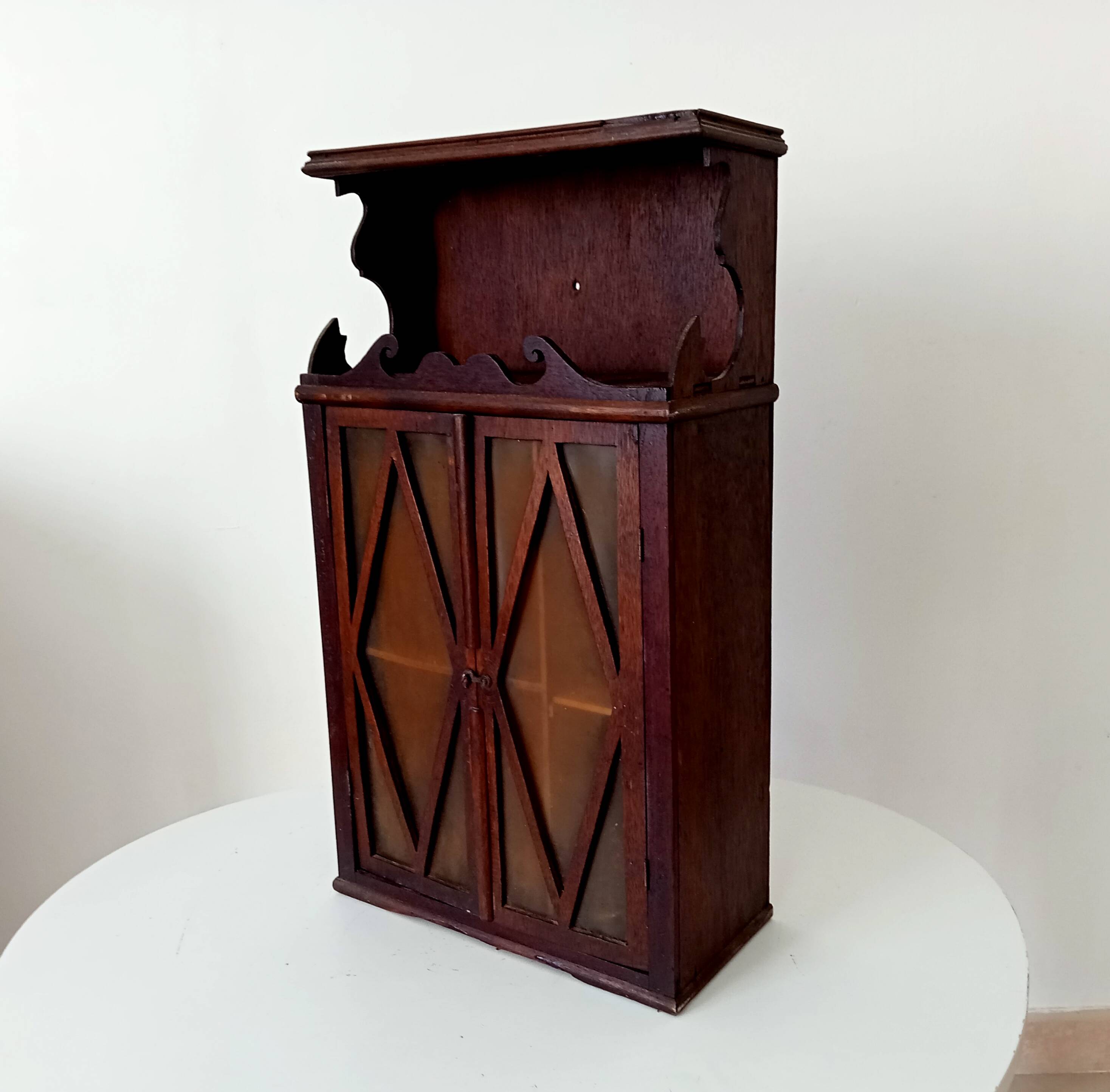 Small antique wall cabinet in Gothic style.