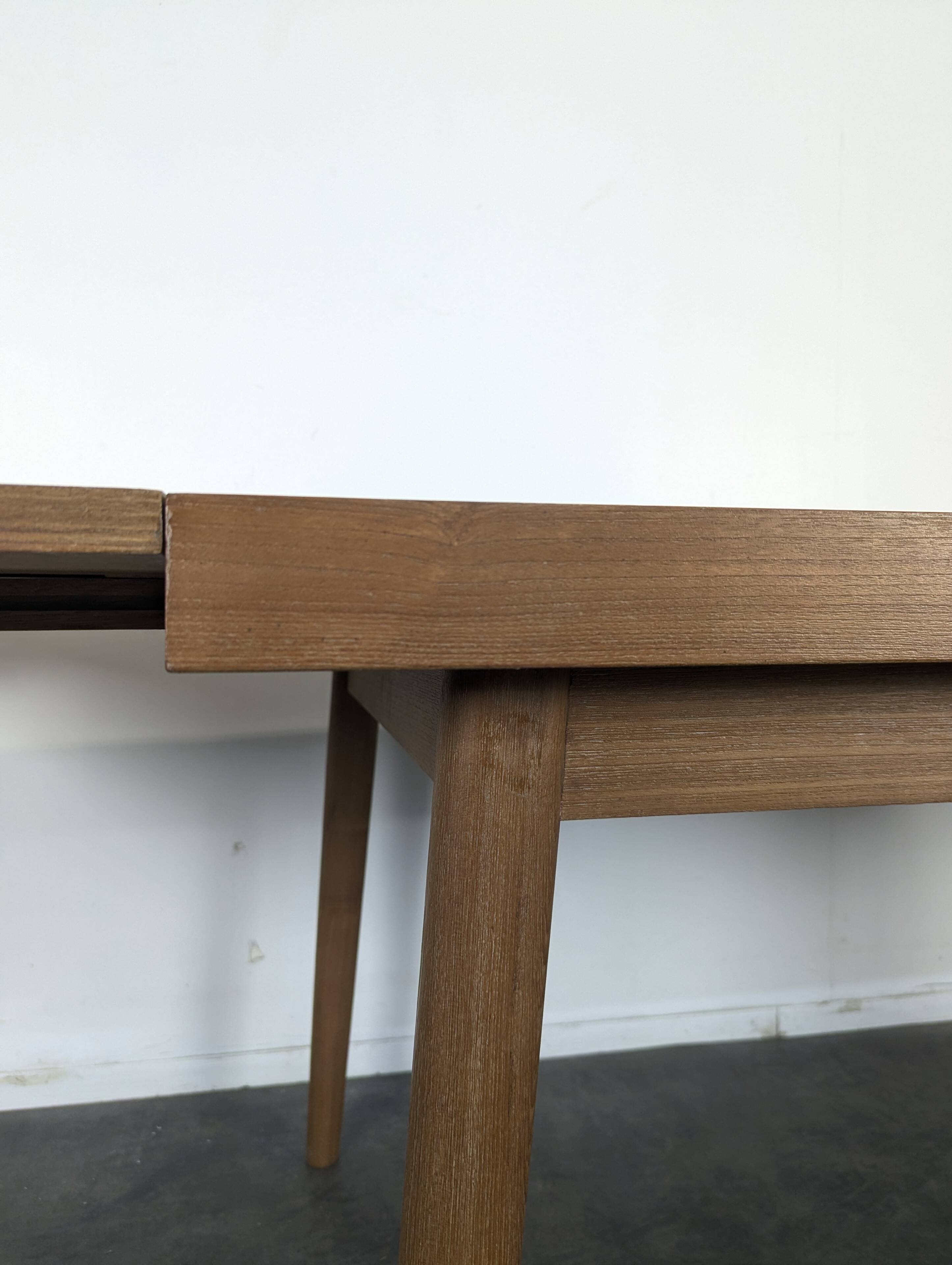 Modernist teak table with 2 extensions.