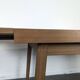 Modernist teak table with 2 extensions.
