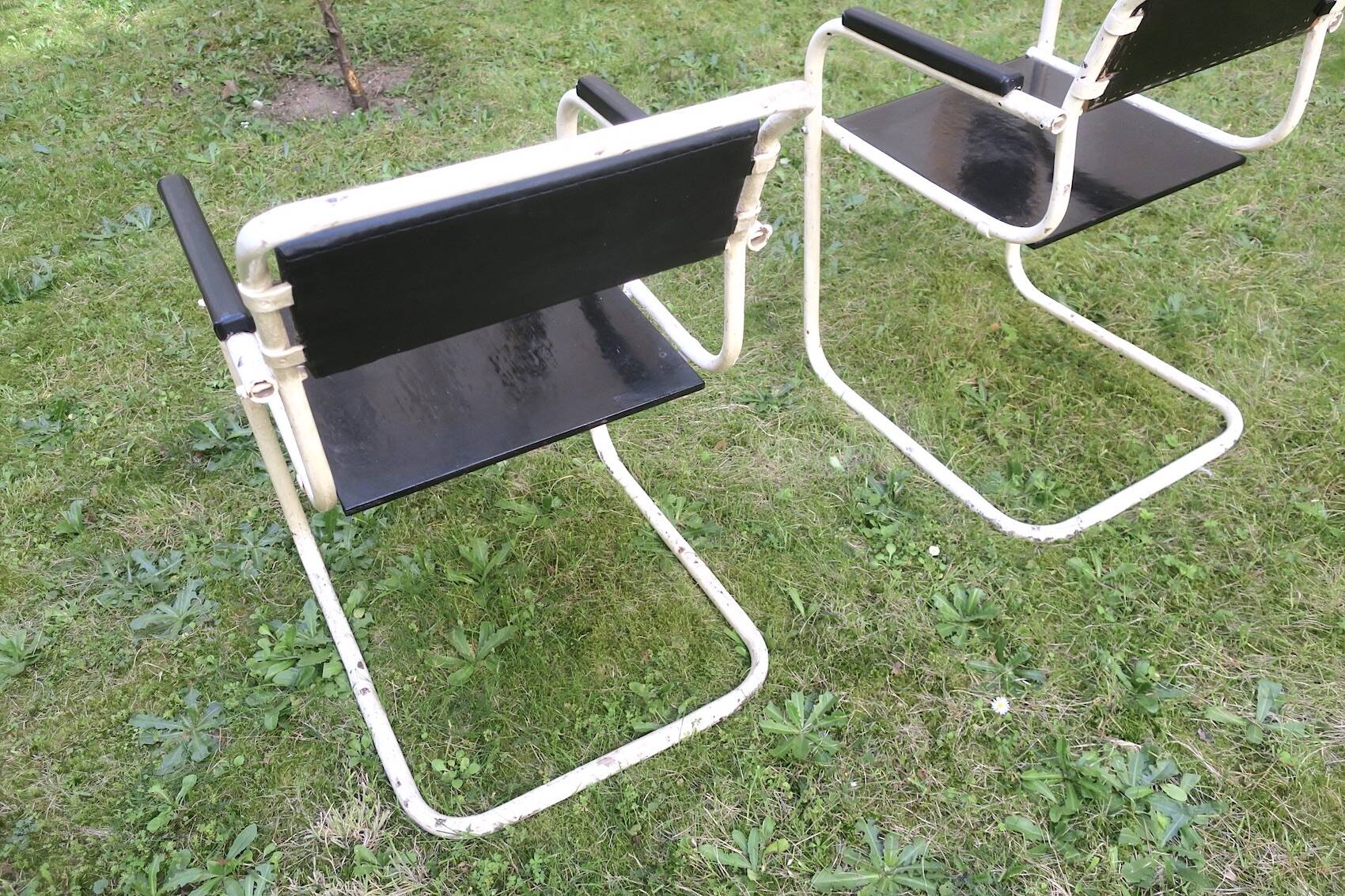 Pair of painted iron and wood cantilever garden chairs, 1930s
