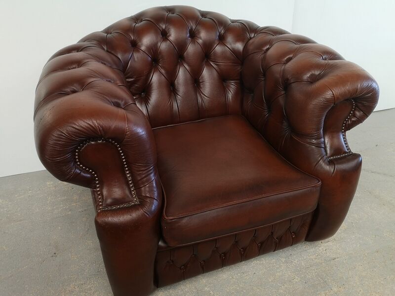 Curved brown leather chesterfield armchair