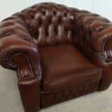 Curved brown leather chesterfield armchair