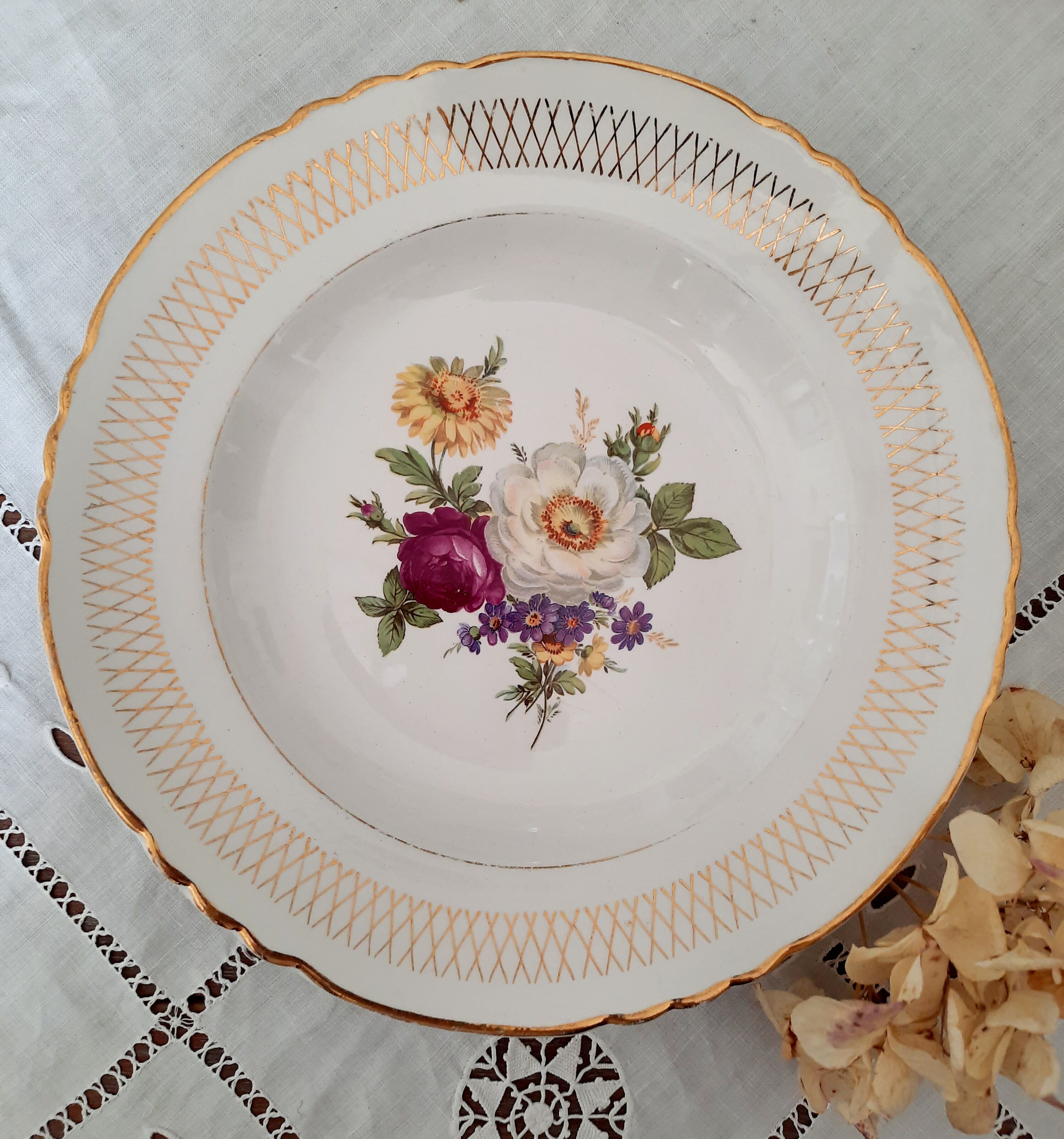 Old hollow plates mismatched in earthenware with gilded edges