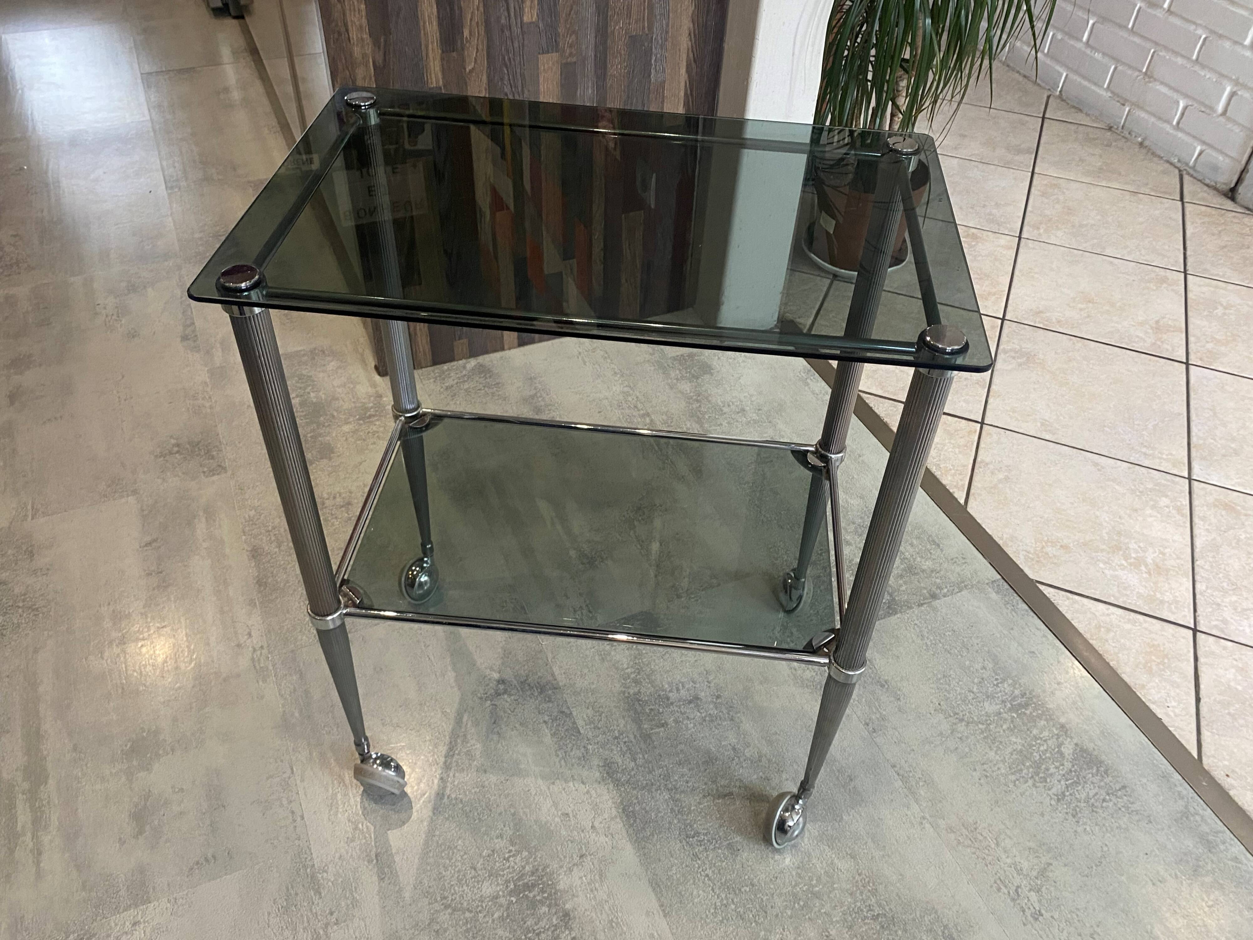 Serving dessert trolley with 2 smoked glass shelves and metal structure.