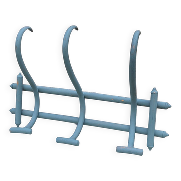 Thonet-style wall coat rack made of painted bent wood.