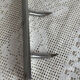 Stainless steel butcher's hook, known as a "wolf tooth bar."