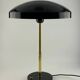 Rare black and gold UFO table lamp by Louis Kalff for Philips.