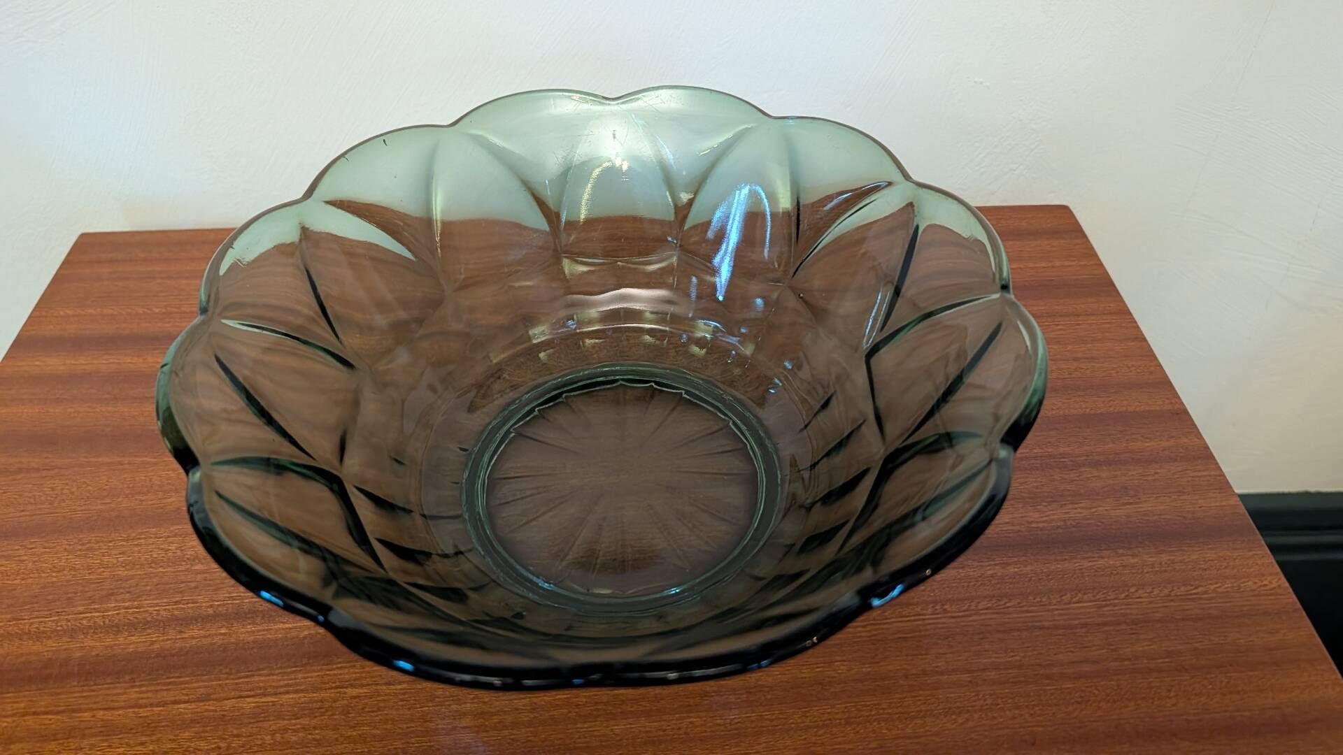 Vintage green smoked glass coupe with geometric decoration.