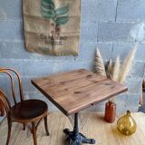 Bistro table with central cast iron leg and rustic top