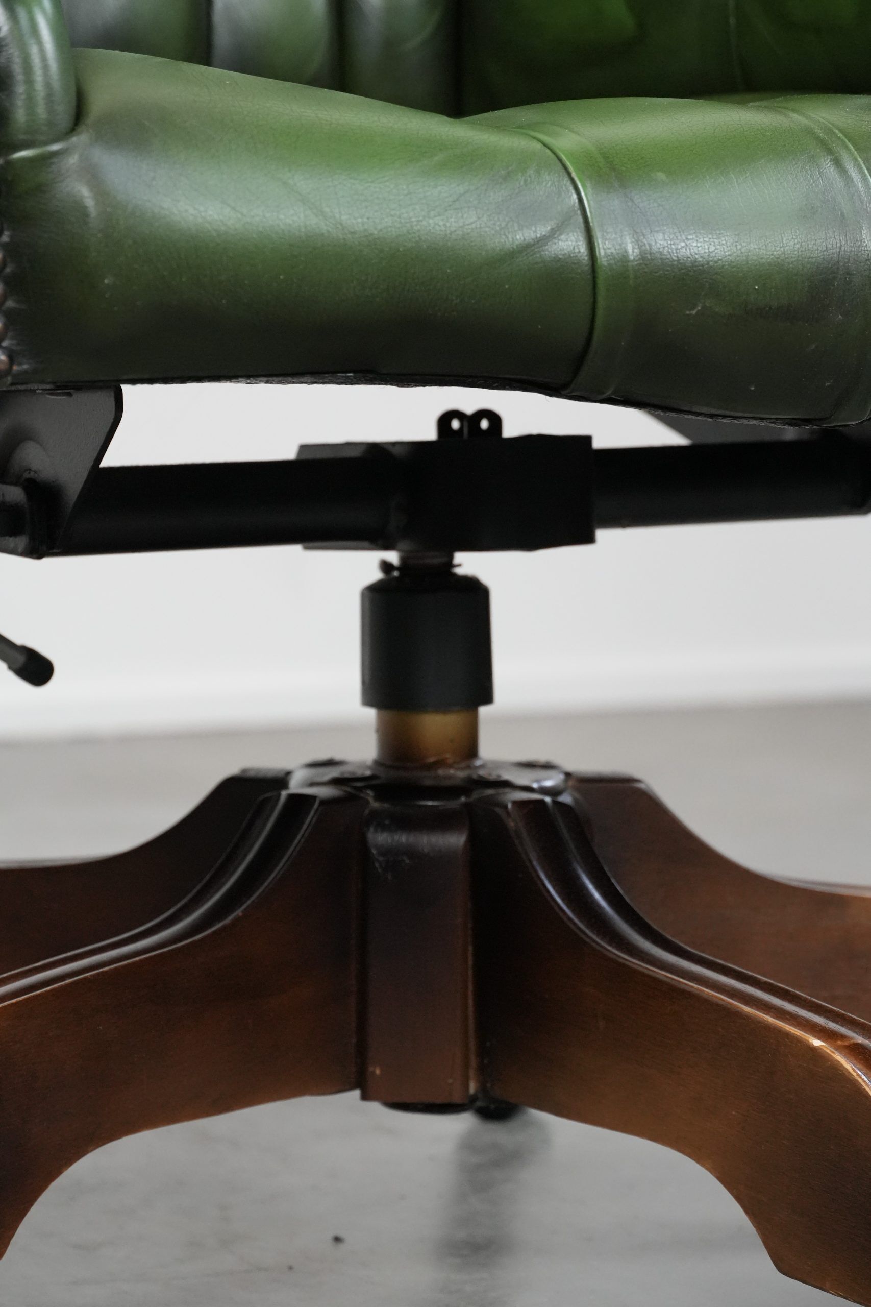 Large green cowhide Chesterfield office chair in English style on wheels