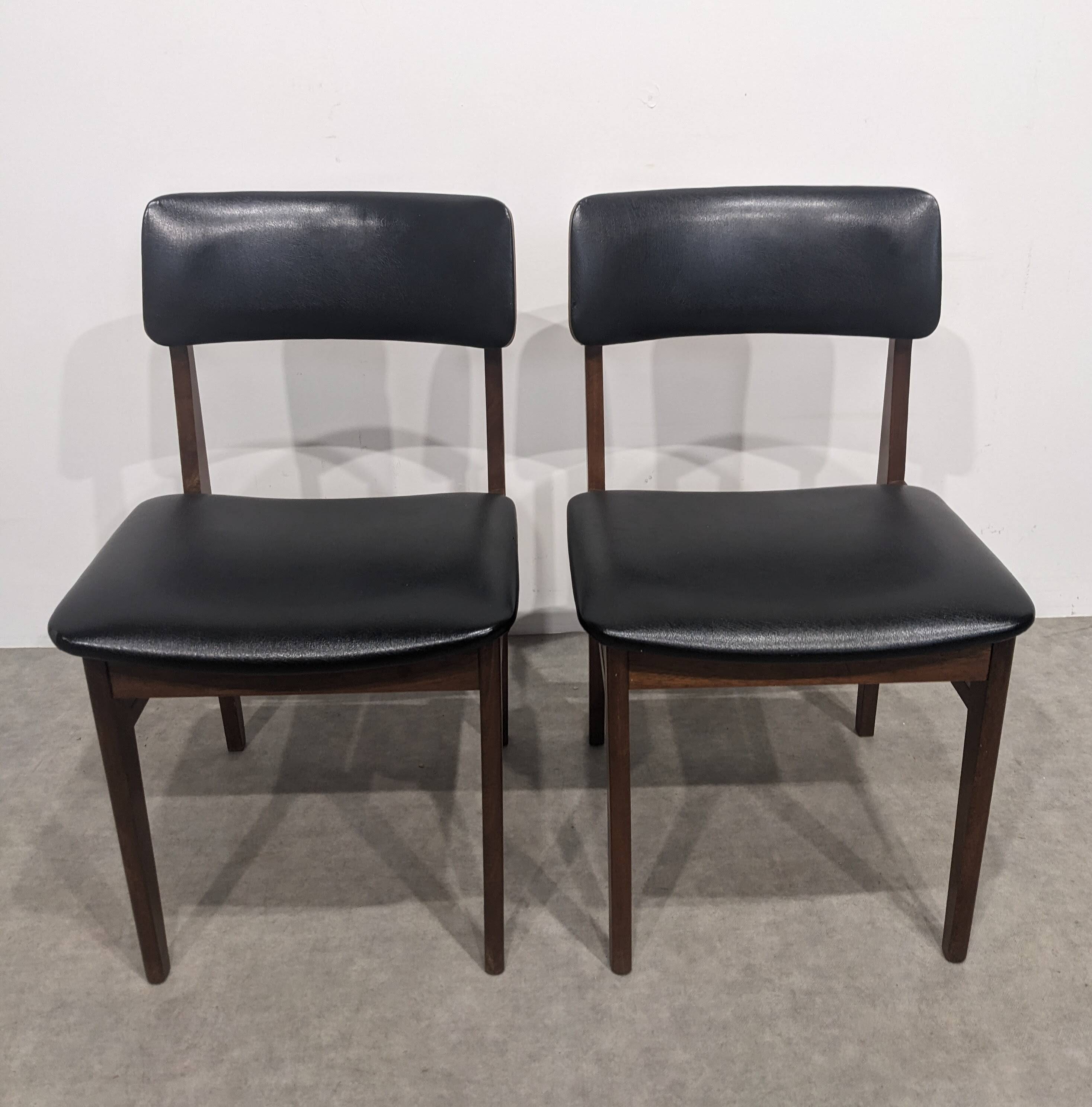 Two mid-century faux leather chairs