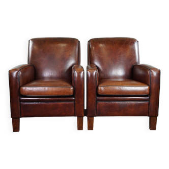 A very beautiful set of 2 Art Deco design armchairs in sheep leather