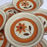 Set 11 plates 1970 Revernay Sarreguemines orange and brown on sandstone background