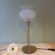 Table lamp with gold metal base and vintage white glass lampshade