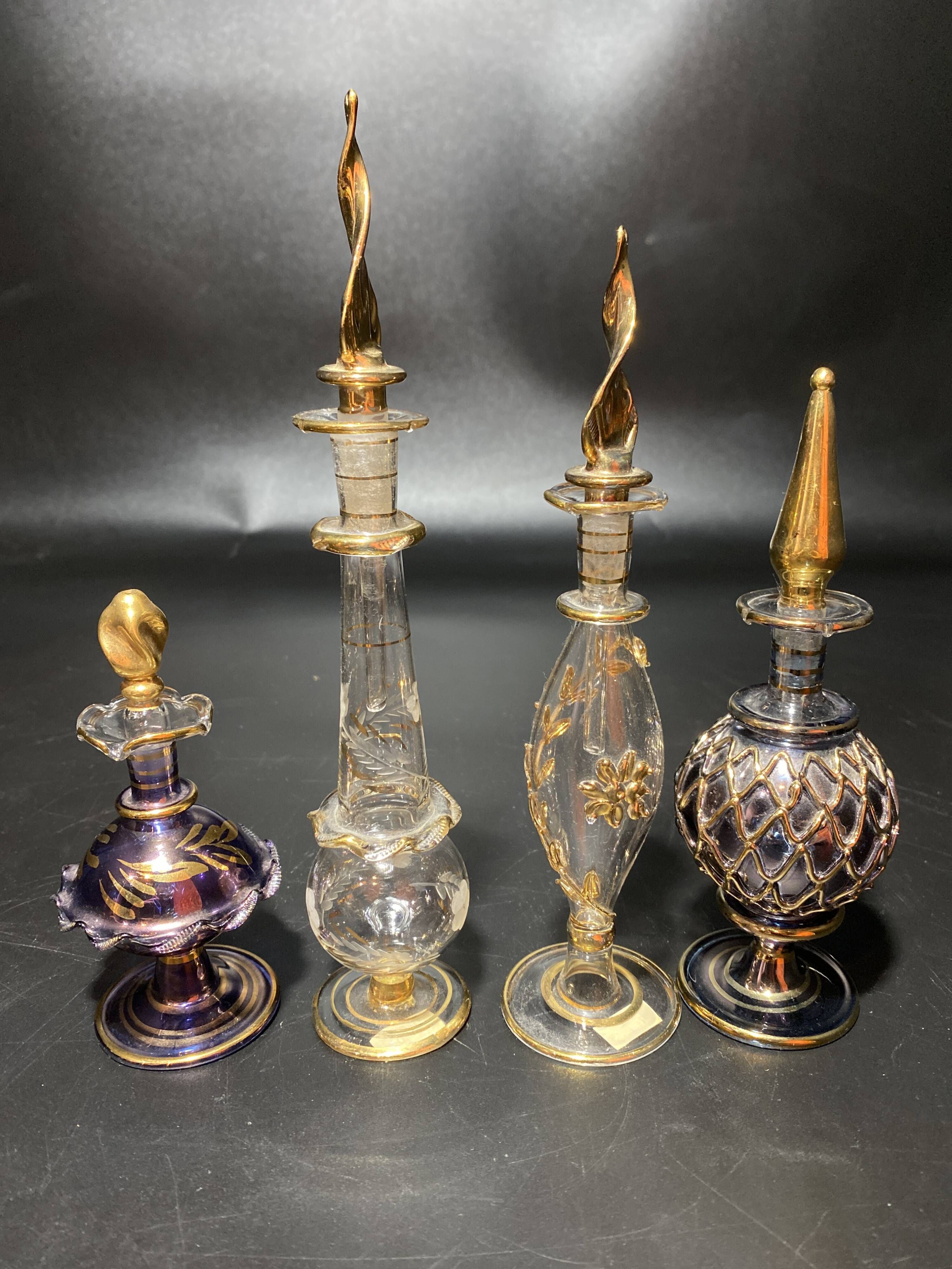 Set of 8 blown glass perfume bottles gilded with 12 carat gold