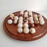 Solitaire game with stone balls