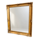 Antique mirror with a gilded frame and foliage decoration.