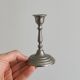 Pair of small metal candle holders, classic design.
