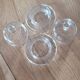 2 transparent glass butter dishes accompanied by their matching cloches.
