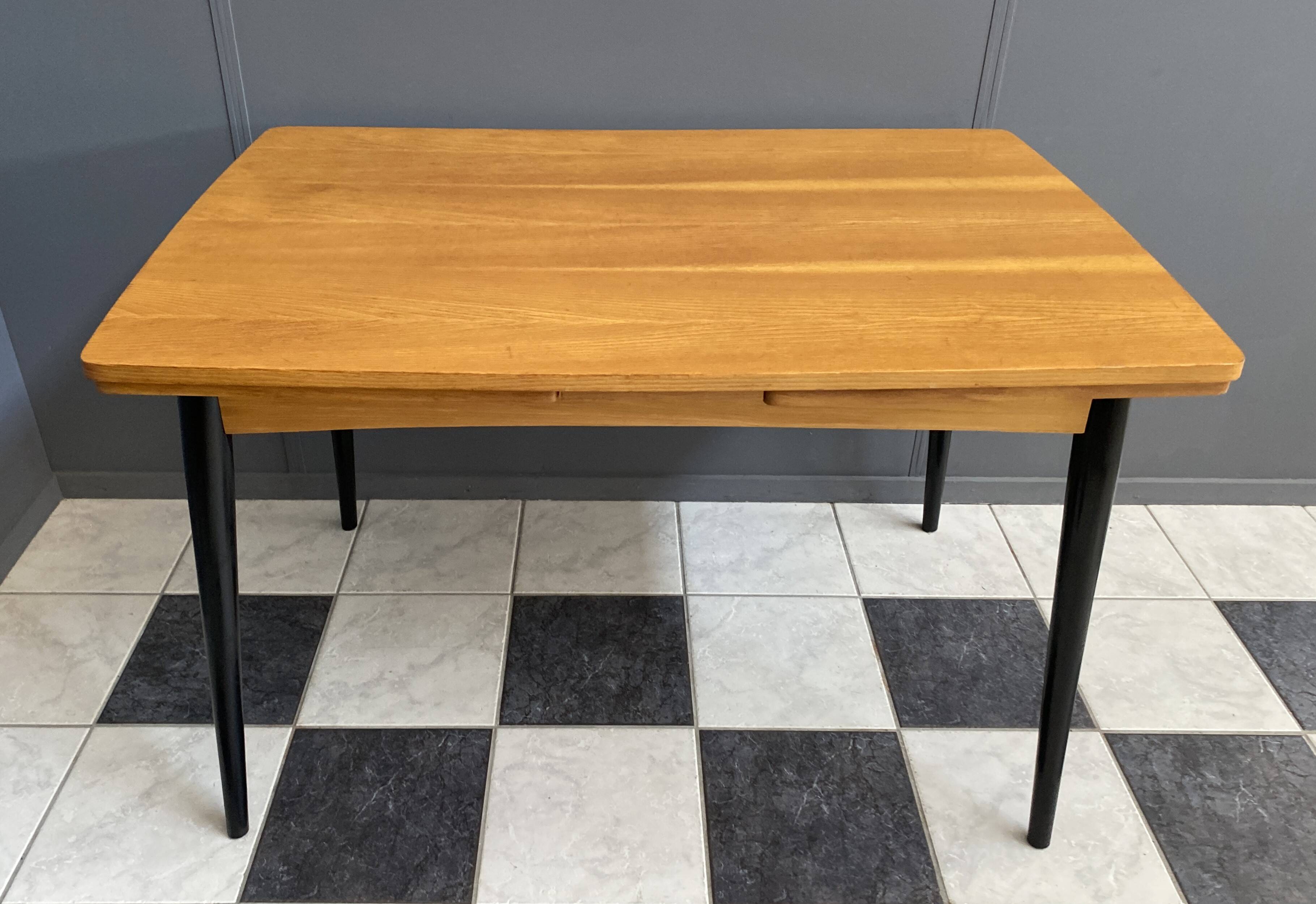 Wood enlarging dining table black wood legs 1960s