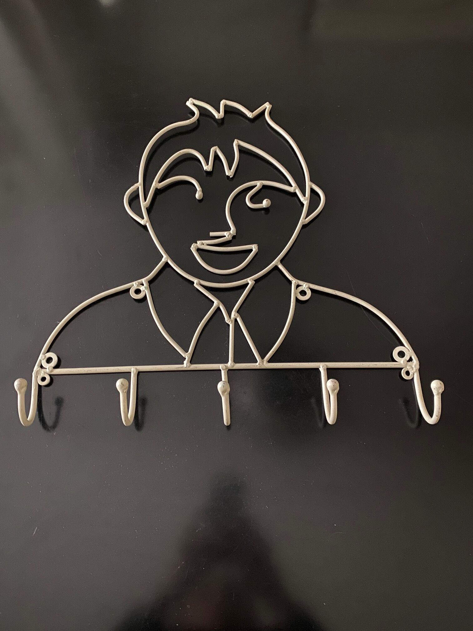 Pair of iron coat holders girl and boy