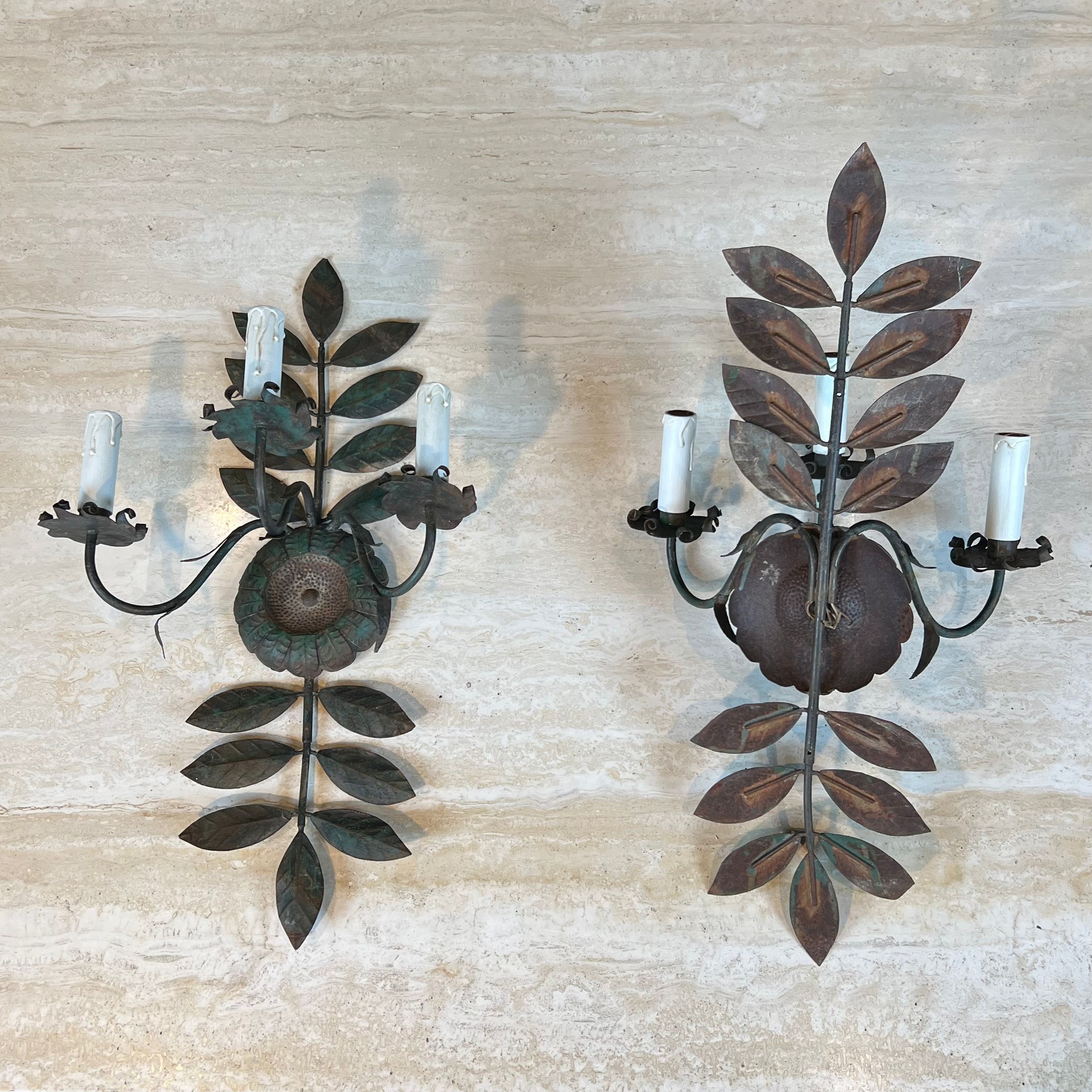 Pair of decorative wall sconces with sunflowers and patinated metal foliage.