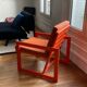 Orange designer armchair by Terence Conran