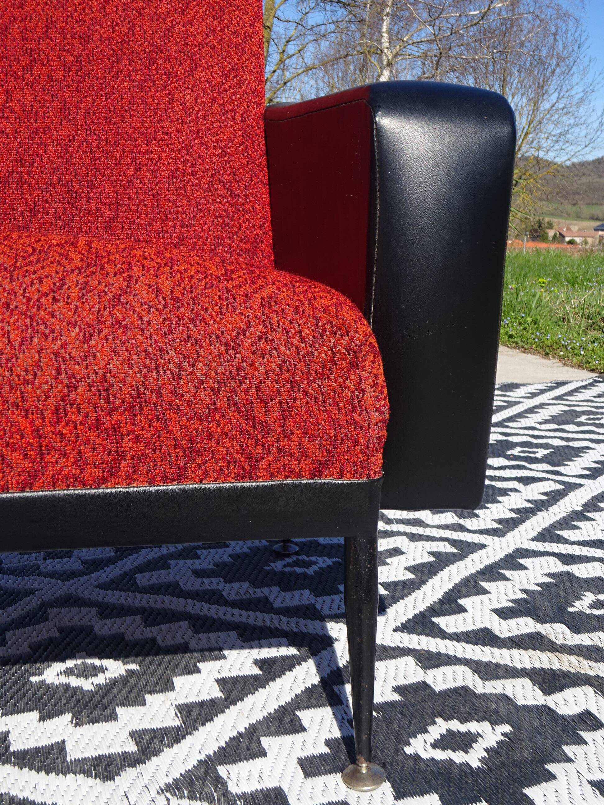 Vintage armchairs in red and black faux leather, the pair.