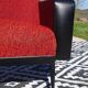 Vintage armchairs in red and black faux leather, the pair.