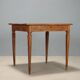 Antique neoclassical walnut coffee table with maple inlays, 18th century.