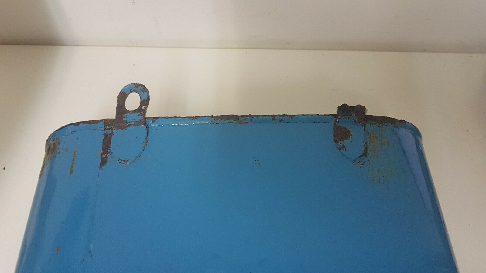 Old hands wash in enamelled sheet metal