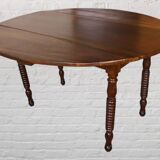 Oval walnut table with flaps