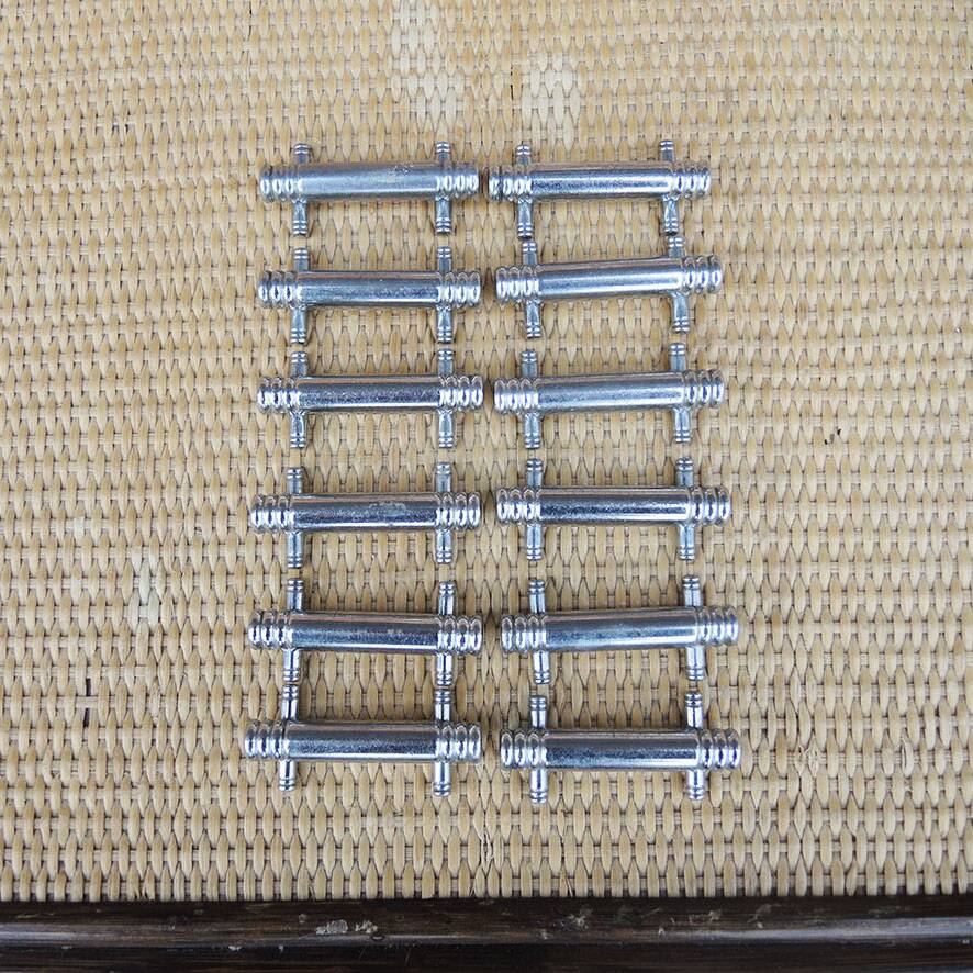 12 vintage Art Deco metal knife rests