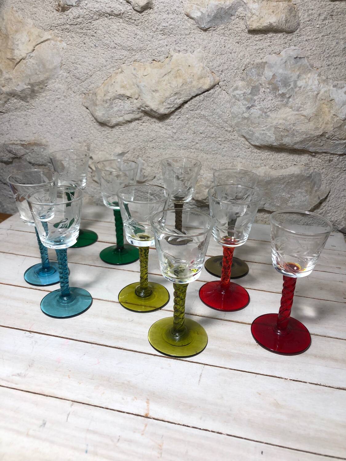 Antique and rare! Sold in a set of 12 colorful twisted stemmed glasses engraved with flowers and leaves