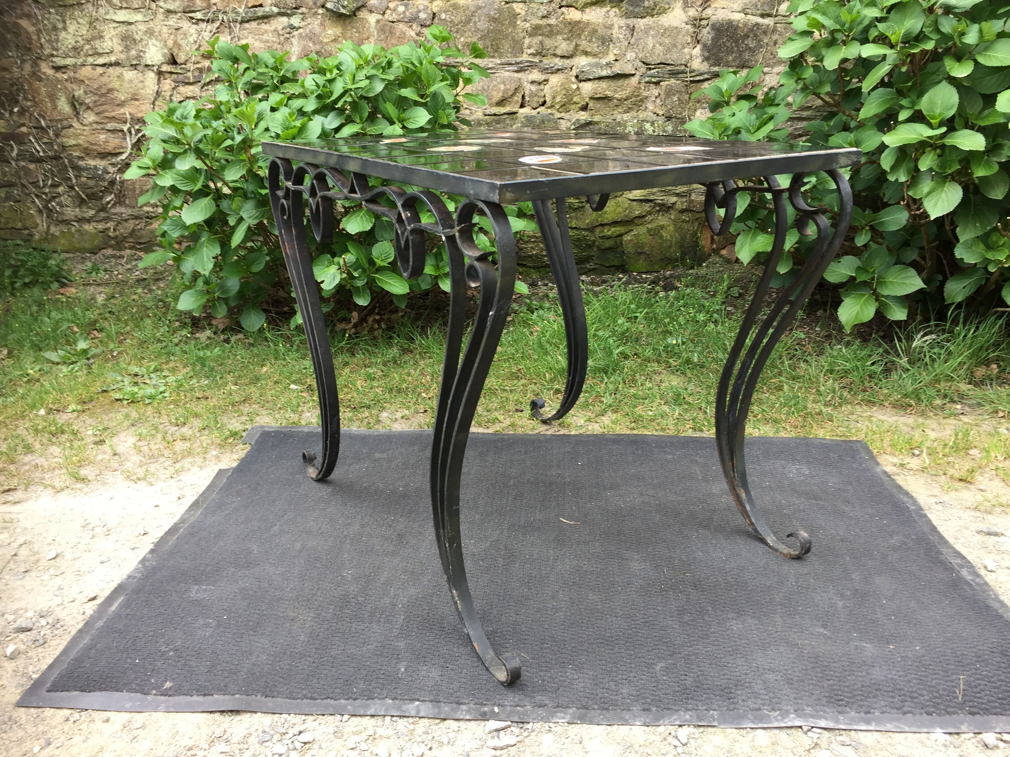Vintage ceramic coffee table by Guy Trévoux with wrought iron base.