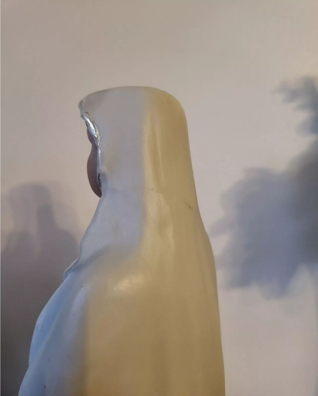 Religious statuette of the Virgin Mary in bisque porcelain