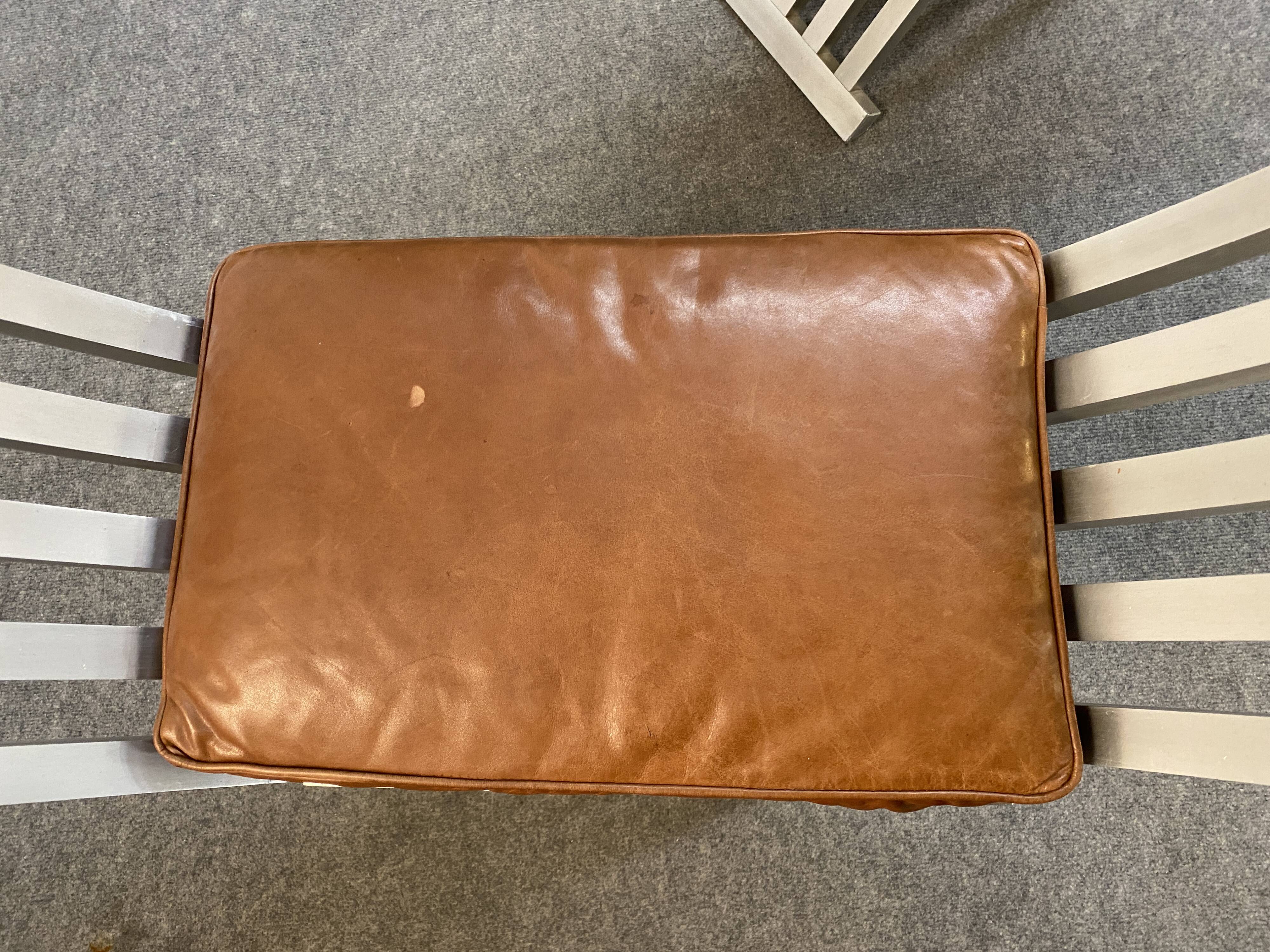 Pair of curule chairs designed by John Vesey, 1958, USA, brushed aluminum, walnut and leather
