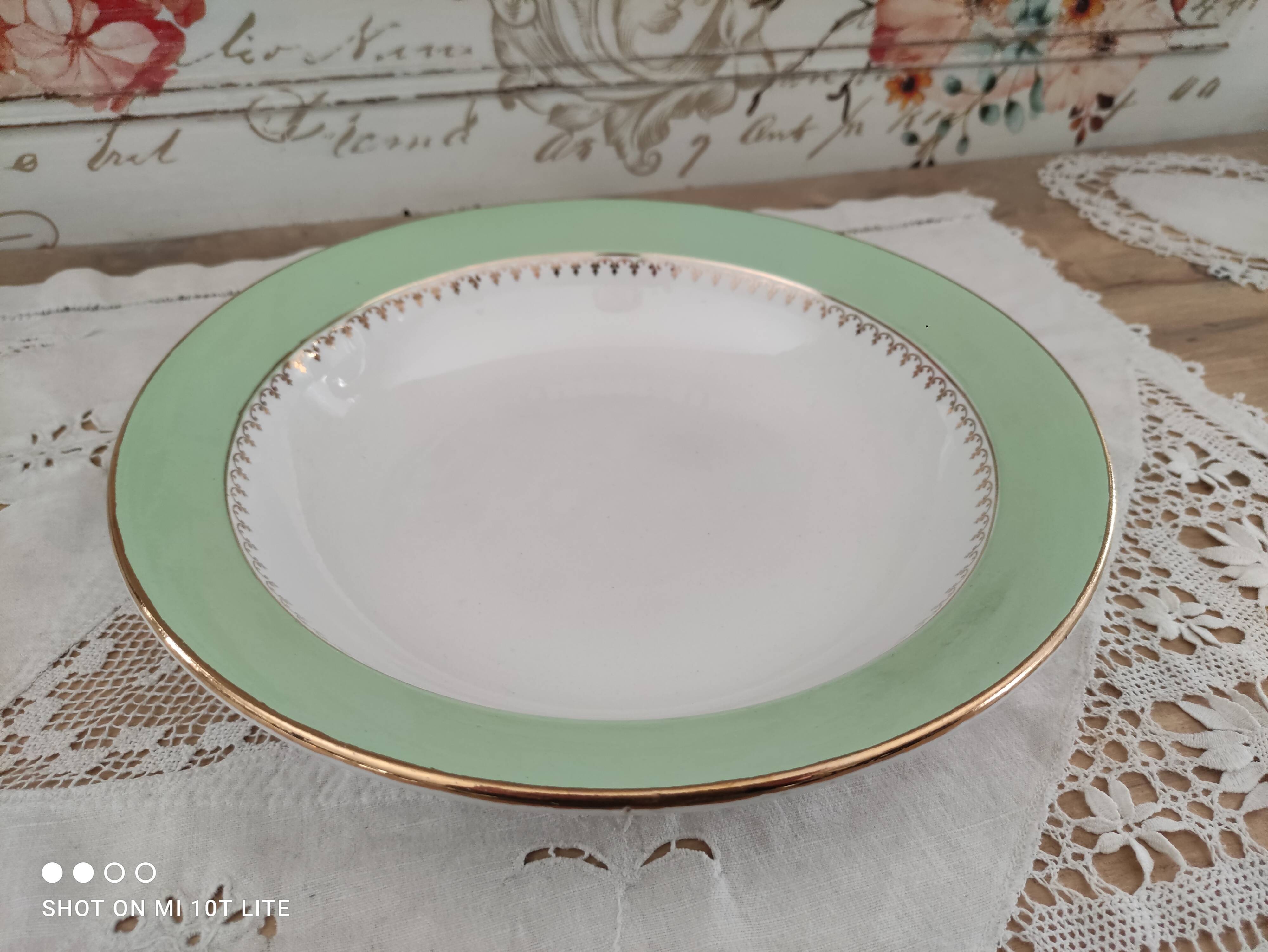 Round hollow plate in water green with a golden frieze, Cafés Lemaire.