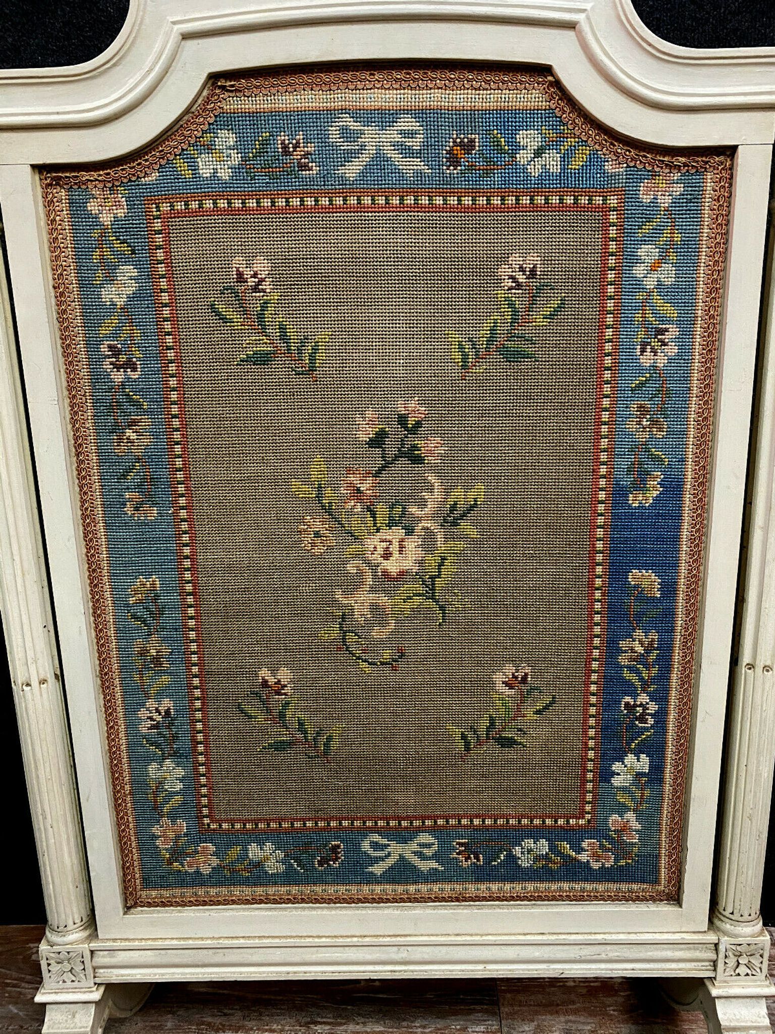 Front of Louis XVI fireplace in laqué wood and fabric has floral decorations