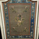 Front of Louis XVI fireplace in laqué wood and fabric has floral decorations