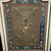 Front of Louis XVI fireplace in laqué wood and fabric has floral decorations