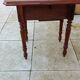 Antique small drop-leaf table from the 19th century.