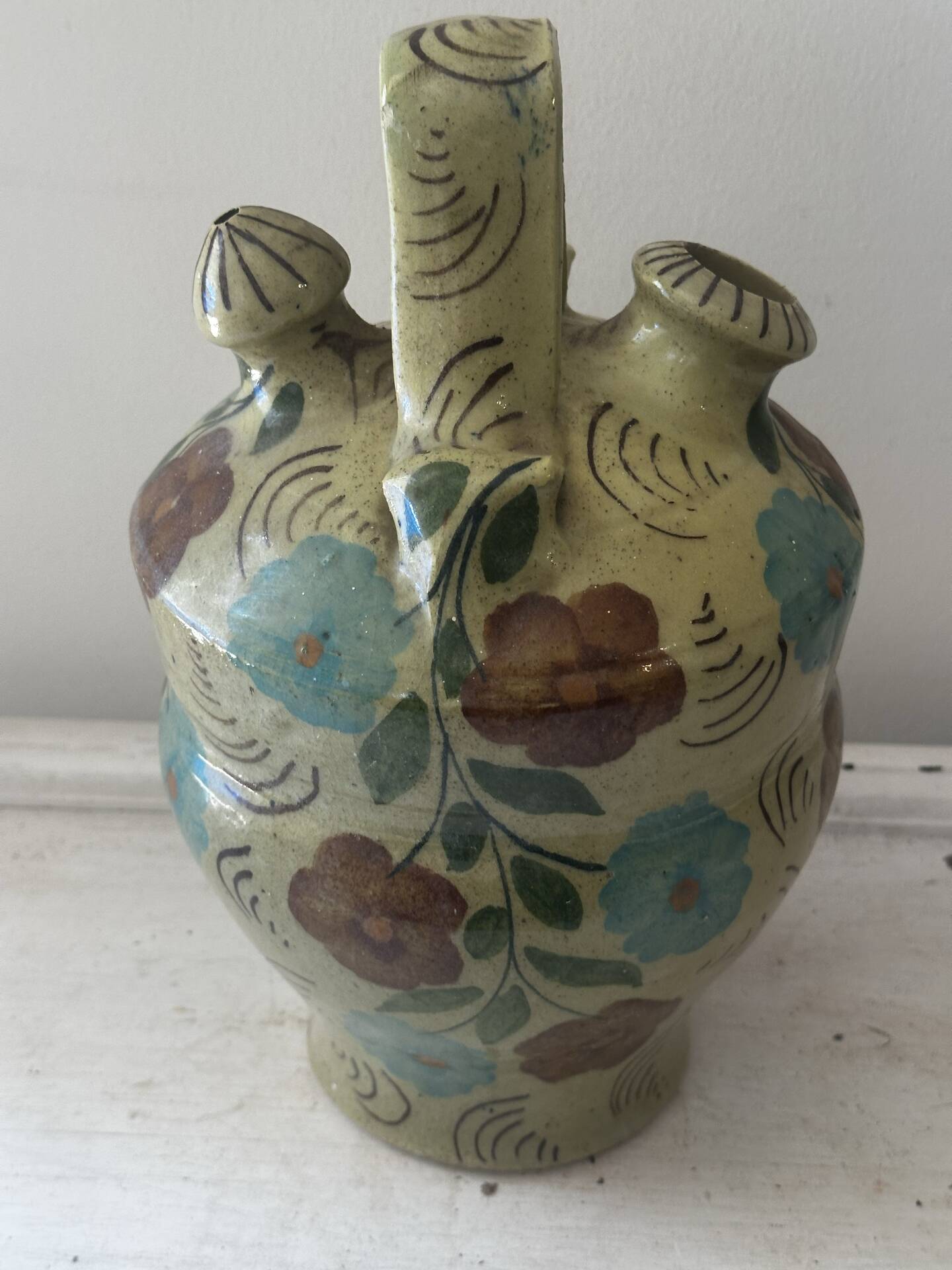 Mediterranean ceramic jug with floral decoration.