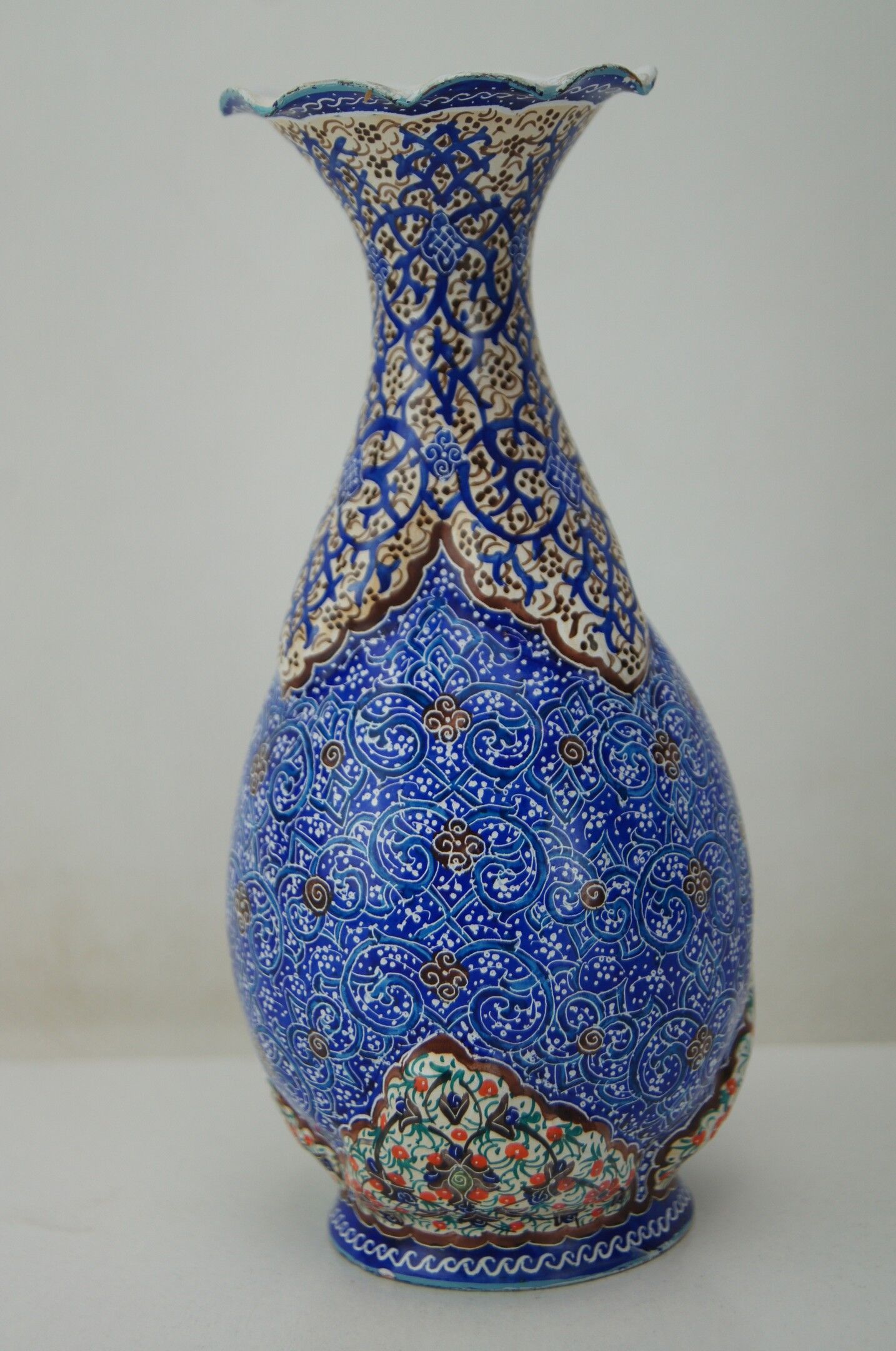 Piriform vase with a flared metal collar enamelled with a polychrome decoration, marked "Amini Iran" on the reverse.