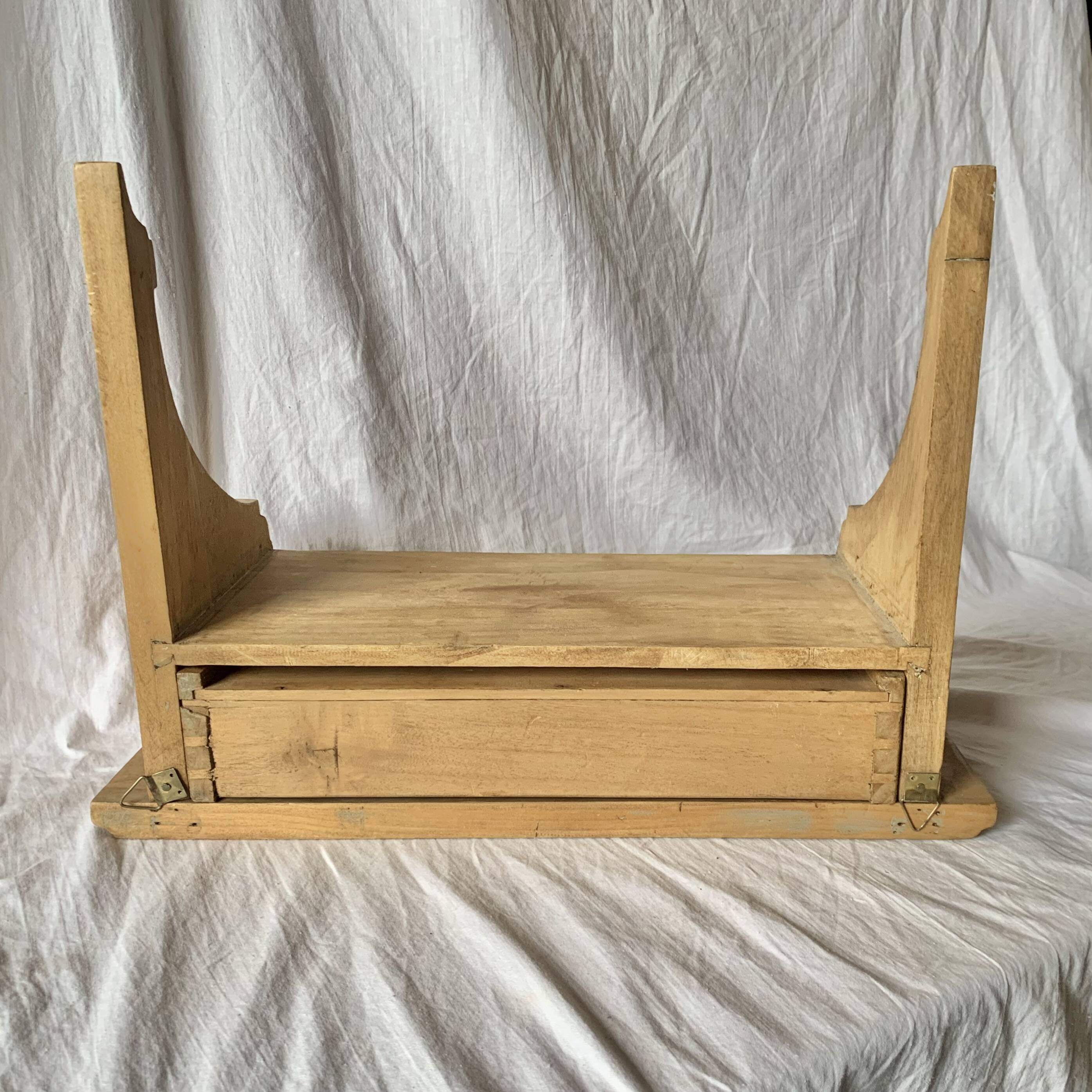 Old small hanging shelf in solid wood