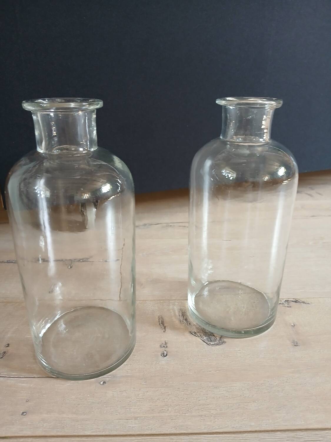 2 large antique transparent glass bottles