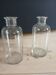 2 large antique transparent glass bottles