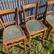 Set of four wooden bistro chairs, green seat, mid-20th century.