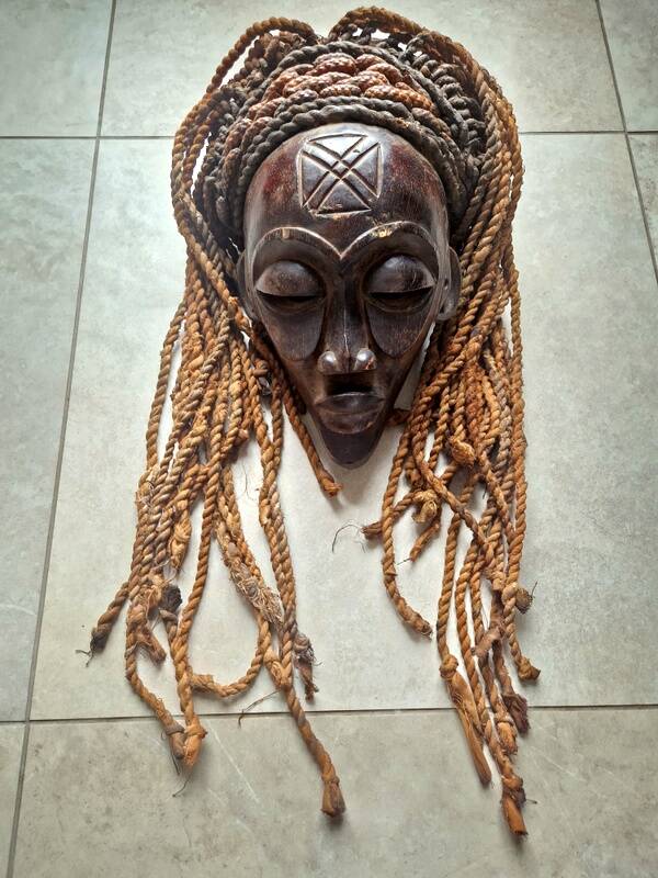Chokwe Mwana Pwo mask in carved wood with a dark patina and rope hair