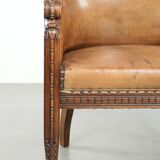 Antique armchair made of sheepskin and wood with decorative nails